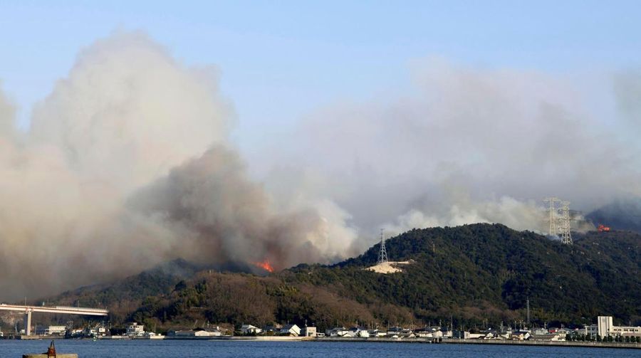 Japan Wildfires Smoke rises from a forest in Okayama, western Japan Sunday, March 23, 2025. (Kyodo News via AP)