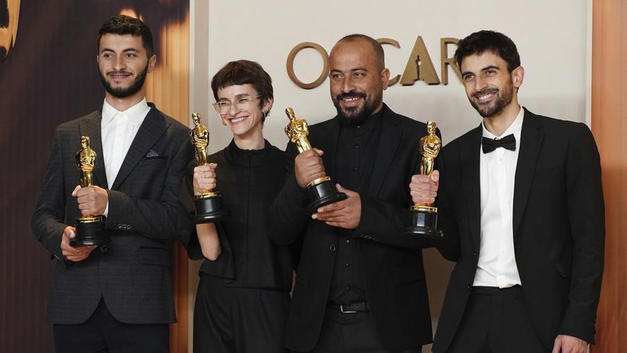 Basel Adra, from left, Rachel Szor, Hamdan Ballal, and Yuval Abraham, winners of the award for best documentary feature film for