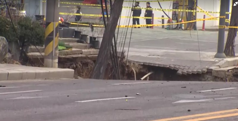 Emergency workers stand near a sinkhole in a road, in Seoul, South Korea, March 25, 2025. Yonhap via REUTERS Emergency workers stand near a sinkhole in a road, in Seoul, South Korea, March 25, 2025. Yonhap via REUTERS