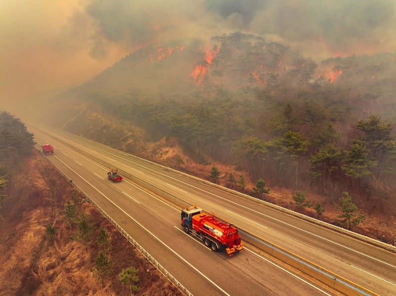 Houses burn in a village after being engulfed by a wildfire fueled by strong winds in Uiseong, South Korea, Monday, March 24, 2025. (Yoon Gwan-shick/Yonhap via AP)