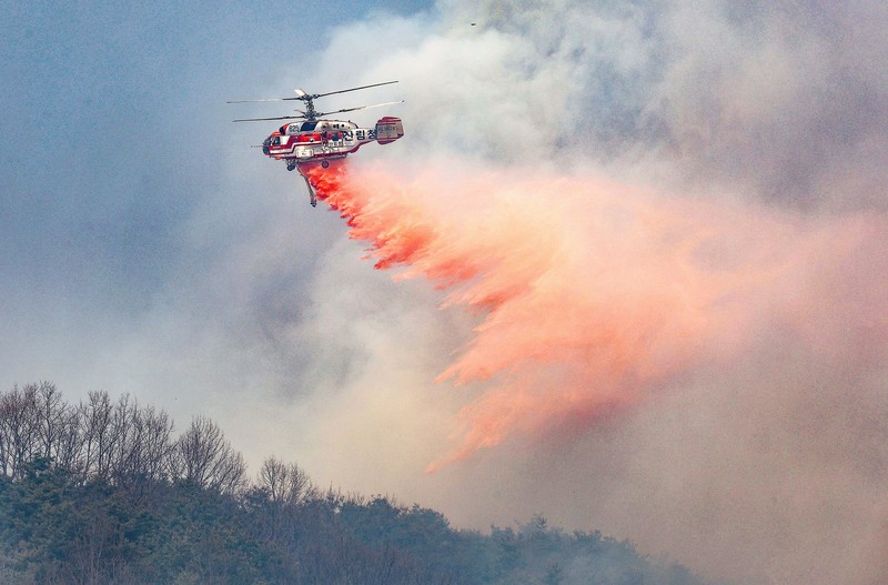 Houses burn in a village after being engulfed by a wildfire fueled by strong winds in Uiseong, South Korea, Monday, March 24, 2025. (Yoon Gwan-shick/Yonhap via AP)