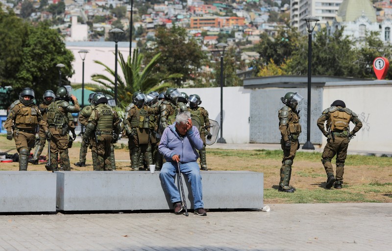 Police officers walk as they hold their shields during a protest against a law being debated that would increase quotas for industrial fishing companies, in Valparaiso Chile March 25, 2025. REUTERS/Pablo Sanhueza     TPX IMAGES OF THE DAY