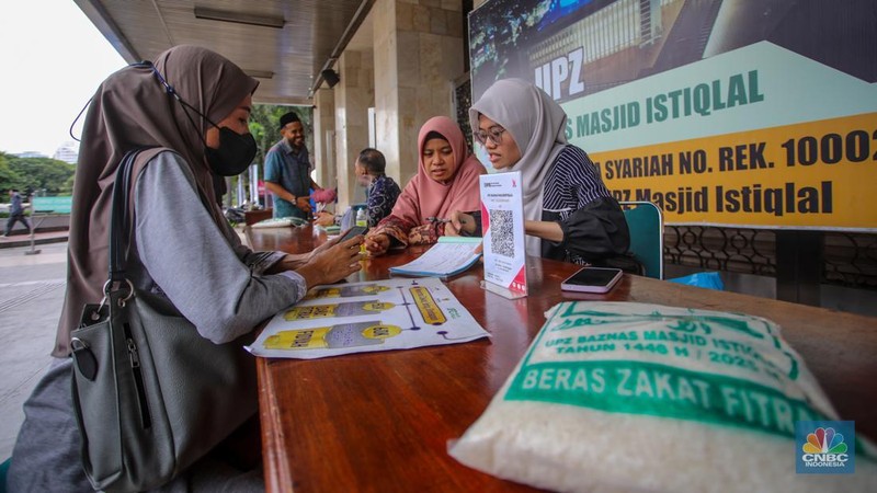 Petugas amil zakat melayani warga yang ingin membayar zakat fitrah di Masjid Istiqlal, Jakarta, Rabu (26/3/2025). (վ/Faisal Rahman)