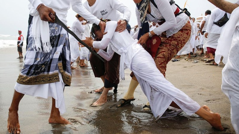Pria Hindu Bali berdoa saat upacara penyucian Melasti menjelang hari suci Nyepi di Gianyar, Bali, Indonesia, 26 Maret 2025. (REUTERS/Johannes P. Christo)