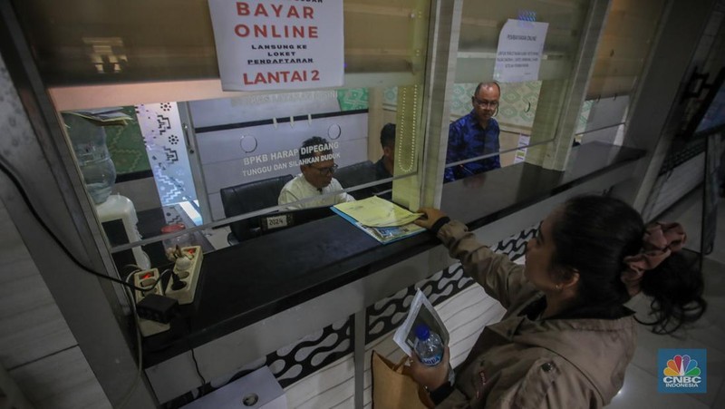 Warga antre untuk melakukan pemeriksaan fisik kendaraan wajib pajak untuk pengurusan pembayaran pajak kendaraan bermotor di kantor Samsat Ciputat, Tangerang Selatan, Banten, Jumat (11/4/2025). (CNBC Indonesia/Faisal Rahman)