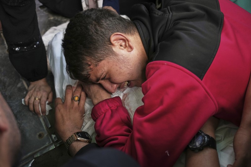 Israel Palestinians Palestinians inspect the damage caused by an Israeli army targeted strike that killed at least three people in Deir al-Balah, central Gaza Strip, Sunday, April 13, 2025. (AP Photo/Abdel Kareem Hana)