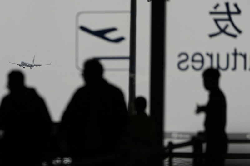 China Wild Winds A traveller walks past by a board showing flights that are cancelled at the Capital International Airport Terminal 3 following gale wind alerts in Beijing, China, Saturday, April 12, 2025. (AP Photo/Ng Han Guan)