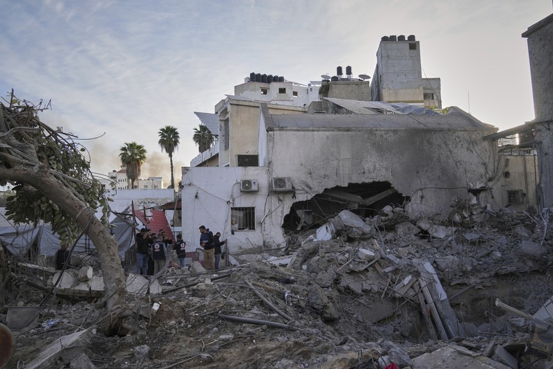 Israel Palestinians Palestinians inspect the damage caused by an Israeli army targeted strike that killed at least three people in Deir al-Balah, central Gaza Strip, Sunday, April 13, 2025. (AP Photo/Abdel Kareem Hana)