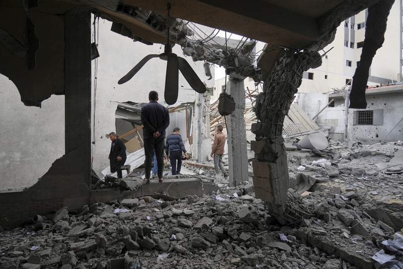 Israel Palestinians Palestinians inspect the damage caused by an Israeli army targeted strike that killed at least three people in Deir al-Balah, central Gaza Strip, Sunday, April 13, 2025. (AP Photo/Abdel Kareem Hana)