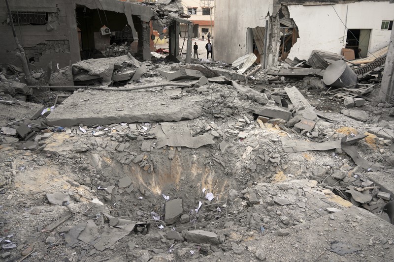 Israel Palestinians Palestinians inspect the damage caused by an Israeli army targeted strike that killed at least three people in Deir al-Balah, central Gaza Strip, Sunday, April 13, 2025. (AP Photo/Abdel Kareem Hana)