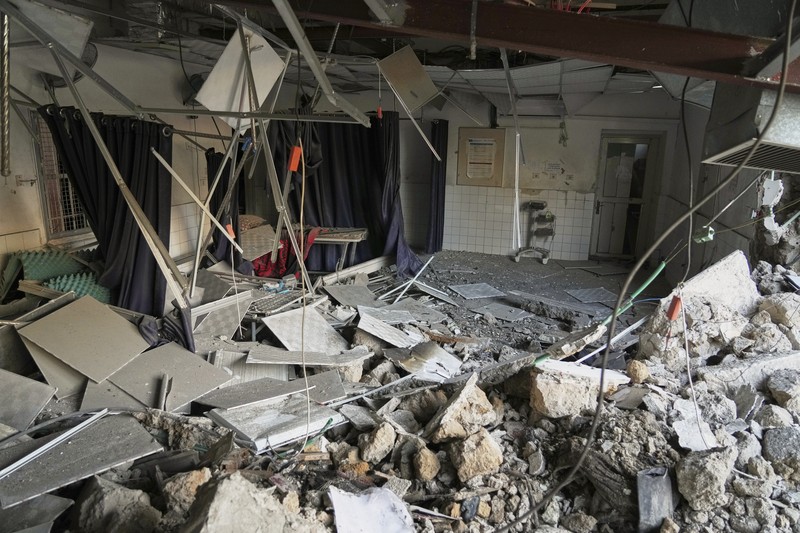 Israel Palestinians Palestinians inspect the damage caused by an Israeli army targeted strike that killed at least three people in Deir al-Balah, central Gaza Strip, Sunday, April 13, 2025. (AP Photo/Abdel Kareem Hana)