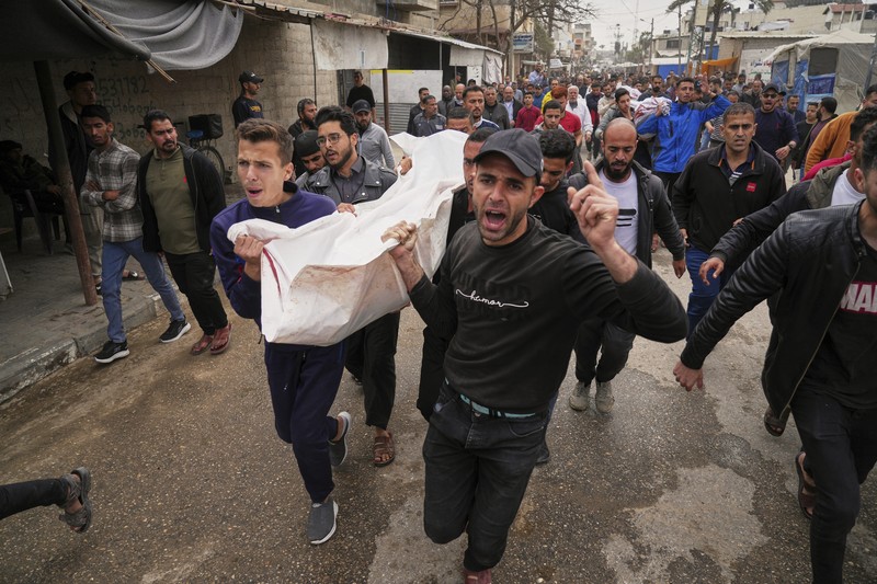 Israel Palestinians Palestinians inspect the damage caused by an Israeli army targeted strike that killed at least three people in Deir al-Balah, central Gaza Strip, Sunday, April 13, 2025. (AP Photo/Abdel Kareem Hana)