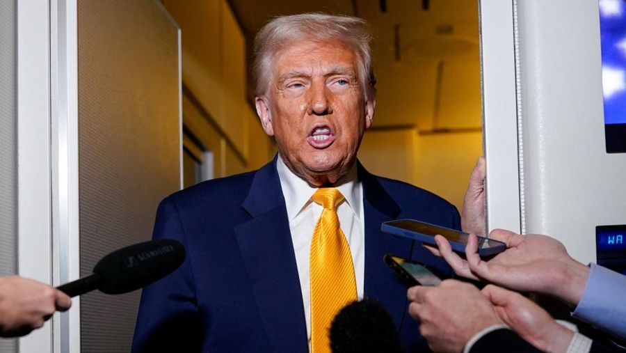 U.S. President Donald Trump speaks to the media on board Air Force One on the way to Miami, Florida, U.S., April 12, 2025. REUTERS/Nathan Howard