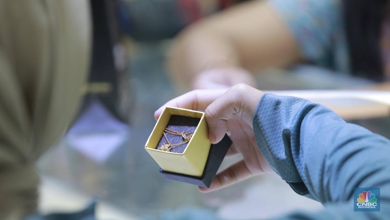 Pengunjung membeli emas perhiasan dan logam mulia di Butik Galeri 24, Jakarta, Selasa (15/4/2025). (CNBC Indonesia/Muhammad Sabki)
