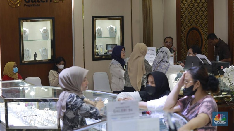Pengunjung membeli emas perhiasan dan logam mulia di Butik Galeri 24, Jakarta, Selasa (15/4/2025). (CNBC Indonesia/Muhammad Sabki)