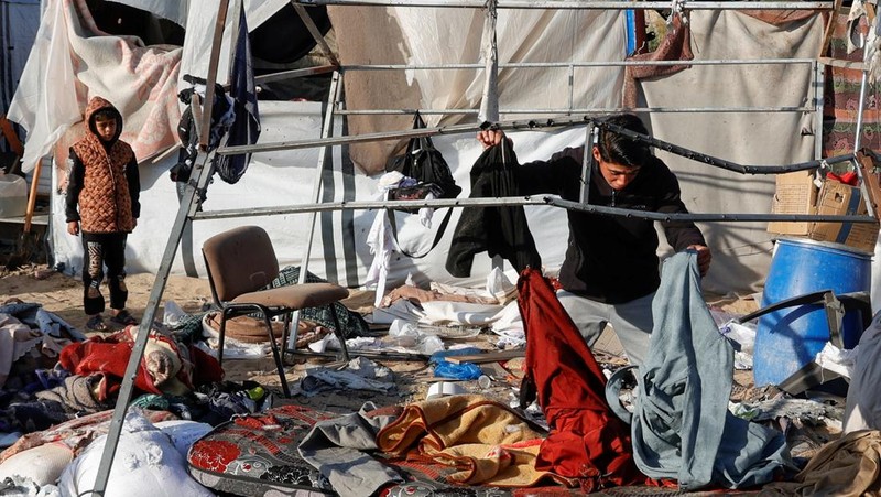 Warga Palestina memeriksa kerusakan di lokasi serangan Israel terhadap tenda yang menampung orang-orang terlantar, di Khan Younis di Jalur Gaza selatan, 15 April 2025. (REUTERS/Hatem Khaled)