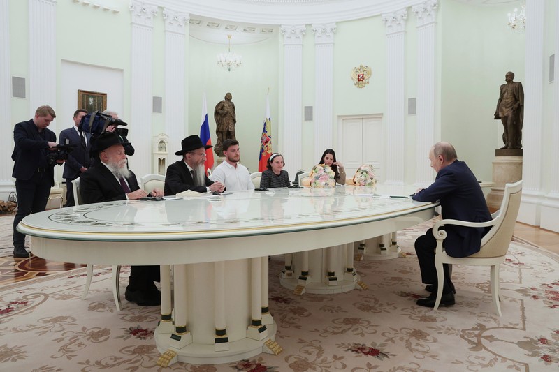 Presiden Rusia Vladimir Putin menemui satu warga Rusia-Israel eks sandera di Jalur Gaza yang baru dilepas Hamas dan diterbangkan ke Moskow, Alexander Trufanov, dan keluarga. (Sandurskaya/Pool via REUTERS)