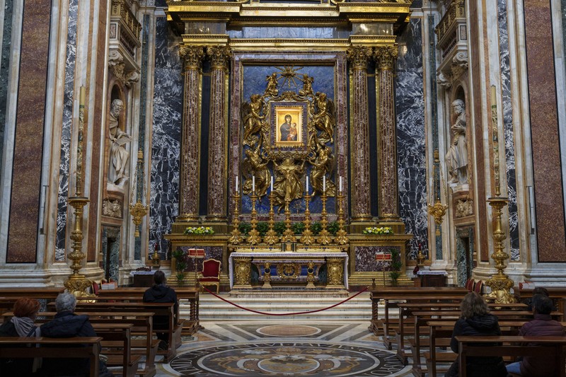 Catholic faithful sit in front an icon of the Virgin Mary at the Santa Maria Maggiore Basilica, Tuesday, Feb. 25, 2025. (AP Photo/Bernat Armangue)