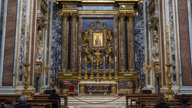 Catholic faithful sit in front an icon of the Virgin Mary at the Santa Maria Maggiore Basilica, Tuesday, Feb. 25, 2025. (AP Photo/Bernat Armangue)