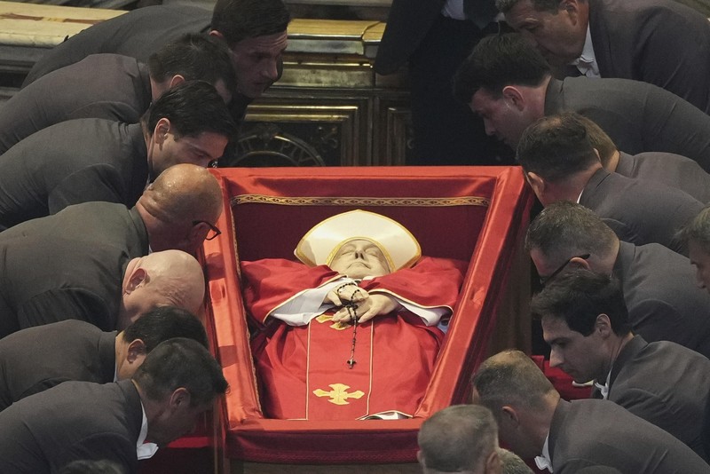 The body of Pope Francis lies inside St. Peter's Basilica at the Vatican, Wednesday, April 23, 2025, where he will lie in state for three days. (AP Photo/Andrew Medichini, Pool)