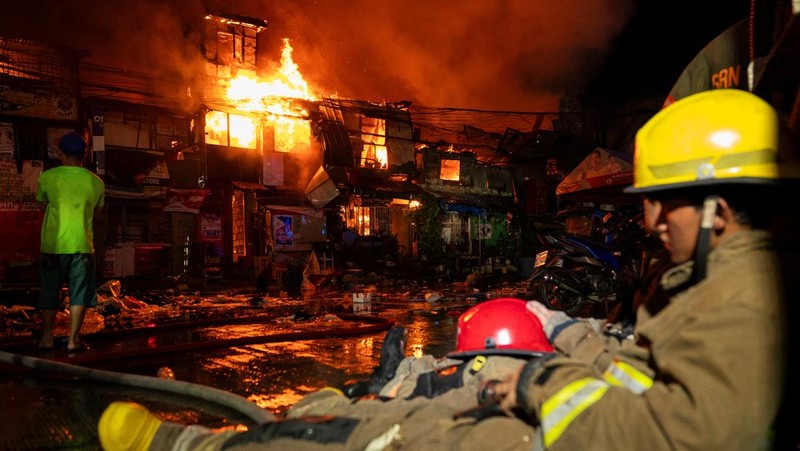 Petugas pemadam kebakaran bekerja memadamkan kebakaran di kawasan pemukiman di Manila, Filipina, 23 April 2025. (REUTERS/Lisa Marie David)