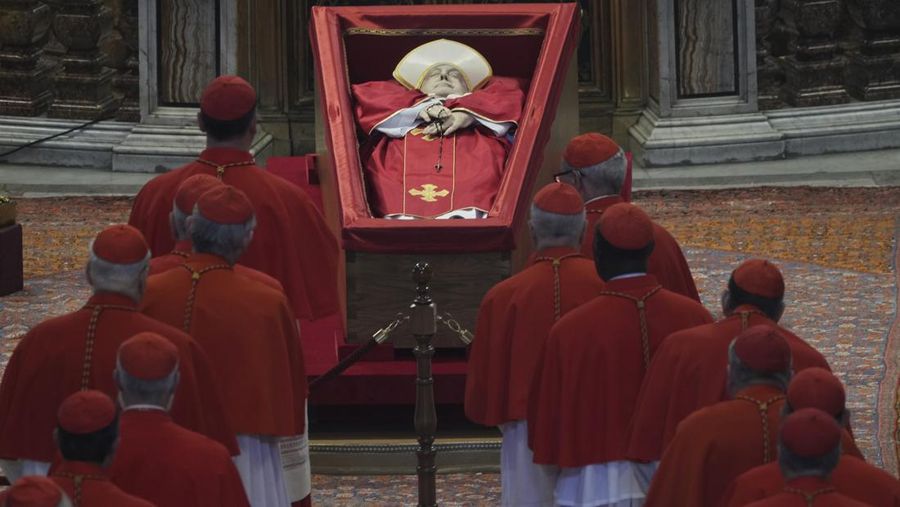 Cardinals pay their respects to Pope Francis inside St. Peter's Basilica at the Vatican, Wednesday, April 23, 2025, where his body will lie in state for three days. (AP Photo/Andrew Medichini, Pool)