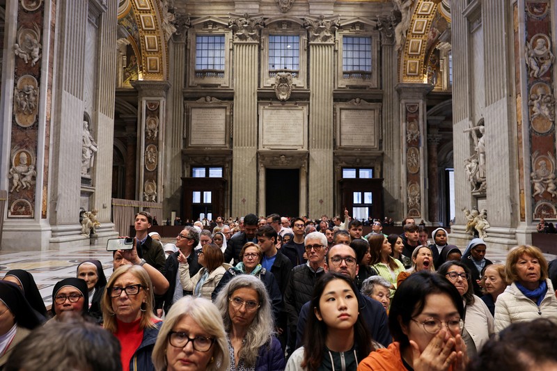 Faithful queue to enter to pay respects to Pope Francis as he lies in state in St. Peter's Basilica, as seen from Rome, Italy, April 23, 2025. REUTERS/Dylan Martinez