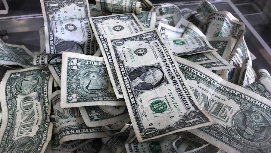 FILE - In this April 3, 2019, file photo a tip box is filled with U.S. currency in New York. If the rate on your savings account is close to the national average and you’re comfortable with an online bank, consider switching to a high-yield account. But if you’re earning a rate above 1% APY, should you opt for a higher one? The short answer is probably no, but it depends. (AP Photo/Mark Lennihan, File)