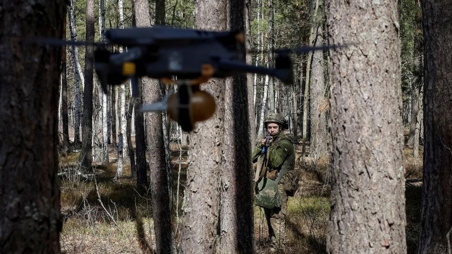 A young recruit of the 28th Knights of the Winter Campaign Separate Mechanised Brigade of the Ukrainian Armed Forces hides from a drone during an exercise, amid Russia's attack on Ukraine, in Kyiv region, Ukraine April 4, 2025. Ukraine's Defence Ministry launched a recruitment drive for young people, 18 to 24-year-olds, to serve in the military for a year for the equivalent of about $24,000 and hefty bonuses. REUTERS/Gleb Garanich TPX IMAGES OF THE DAY