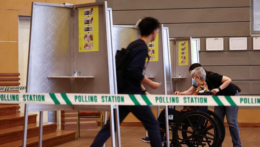 Warga memberikan suaranya di tempat pemungutan suara selama pemilihan umum di Singapura, Sabtu (3/5/2025). (REUTERS/Edgar Su)