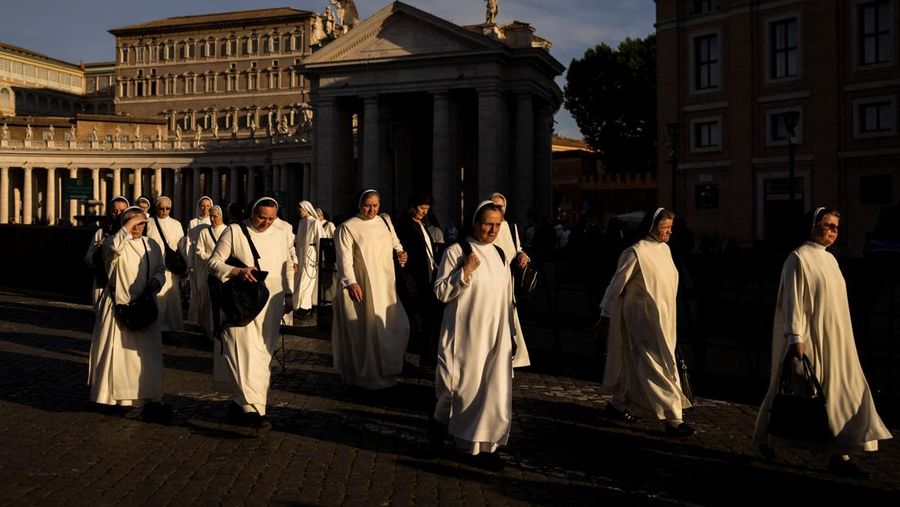 Para biarawati berjalan di luar Lapangan Santo Petrus di Vatikan menjelang konklaf dan pemilihan paus baru yang akan diadakan pada 7 Mei, seperti yang terlihat dari Roma, Italia, 3 Mei 2025. (REUTERS/Eloisa Lopez)