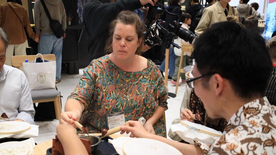 Sejumlah pengunjung World Expo 2025 Osaka, Jepang mencoba membuat batik Liem Ping Wie. (Dok. Kementerian PPN/Bappenas)