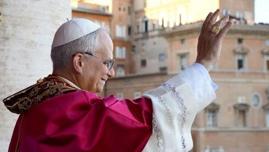 This photo taken and handout on May 7, 2025 by The Vatican Media shows Newly elected Pope Leo XIV, Robert Prevost addressing the crowd from the main central loggia balcony of the St Peter's Basilica for the first time, after the cardinals ended the conclave, in The Vatican. (Photo by Handout / VATICAN MEDIA / AFP) / RESTRICTED TO EDITORIAL USE - MANDATORY CREDIT