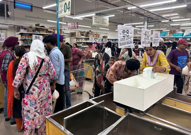 People shop for essential goods at a supermarket in Amritsar, India, May 9, 2025. REUTERS/Francis Mascarenhas