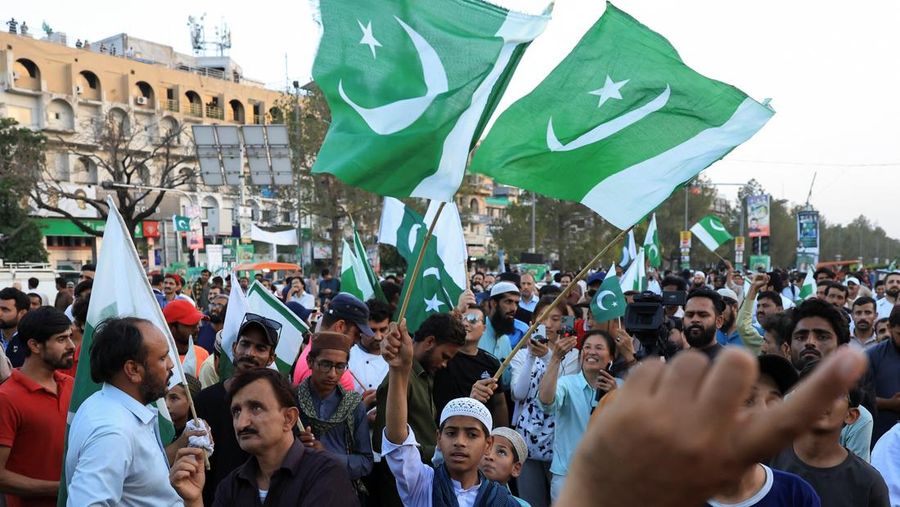 Sejumlah warga mengibarkan bendera Pakistan saat perayaan setelah pengumuman gencatan senjata antara India dan Pakistan, di Islamabad, Pakistan, 10/5/2025. REUTERS/Akhtar Soomro