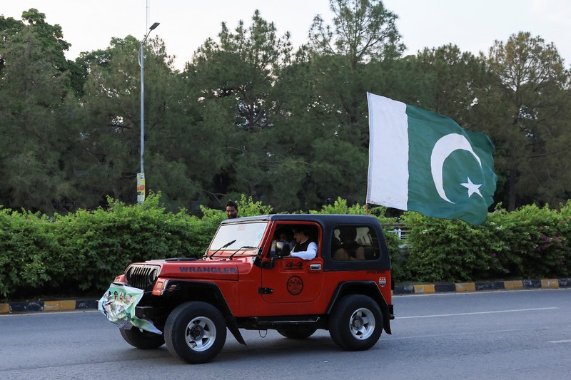 INDIA-PAKISTAN/ Sejumlah warga mengibarkan bendera Pakistan saat perayaan setelah pengumuman gencatan senjata antara India dan Pakistan, di Islamabad, Pakistan, 10/5/2025. REUTERS/Akhtar Soomro