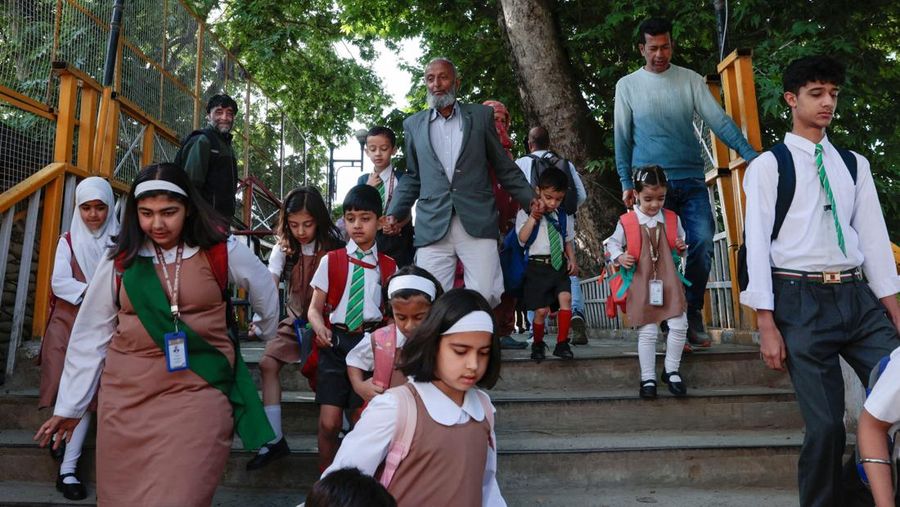 INDIA-PAKISTAN/ Students attend morning assembly as schools reopen following the ceasefire announcement between India and Pakistan, in Muzaffarabad, Pakistani Kashmir, May 13, 2025. REUTERS/Naseer ud Din