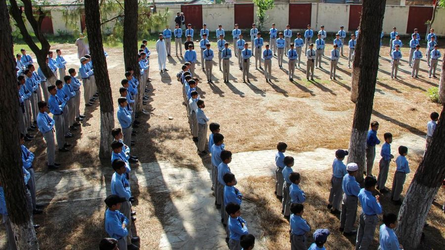 INDIA-PAKISTAN/ Students attend morning assembly as schools reopen following the ceasefire announcement between India and Pakistan, in Muzaffarabad, Pakistani Kashmir, May 13, 2025. REUTERS/Naseer ud Din