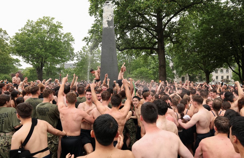 Para anggota Plebe berlomba untuk memulai tugas mereka membentuk piramida manusia untuk memanjat Monumen Herndon, sebuah obelisk granit setinggi 21 kaki, yang dilapisi dengan lapisan tebal lemak nabati, dalam ritual tahunan yang menandai selesainya kelas tahun pertama di Akademi Angkatan Laut AS di Annapolis, Maryland, AS, 14 Mei 2025. Para anggota Plebe berlomba untuk memulai tugas mereka membentuk piramida manusia untuk memanjat Monumen Herndon, sebuah obelisk granit setinggi 21 kaki, yang dilapisi dengan lapisan tebal lemak nabati, dalam ritual tahunan yang menandai selesainya kelas tahun pertama di Akademi Angkatan Laut AS di Annapolis, Maryland, AS, 14 Mei 2025. (REUTERS/Kevin Lamarque)