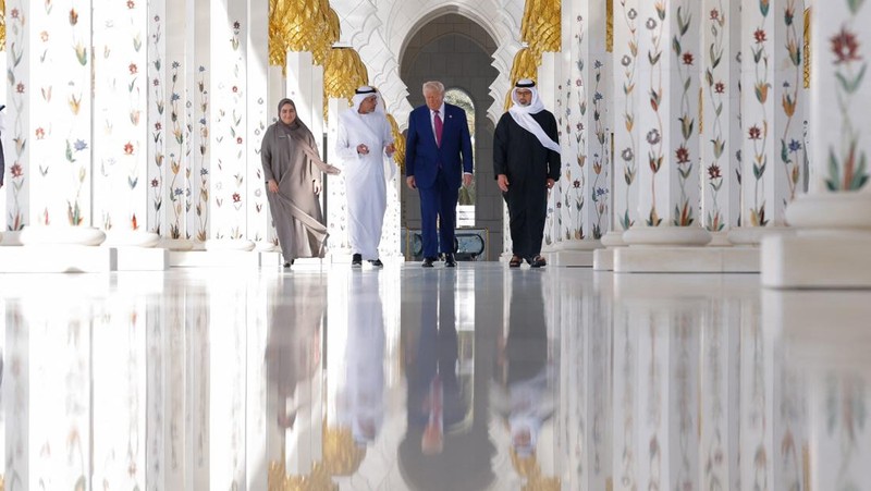 U.S. President Donald Trump is reflected off the floor as he walks with Yousif Al Obaidli, director of Sheikh Zayed Grand Mosque and Ameena Al Hammadi, acting director of the Culture and Knowledge Department while visiting the Sheikh Zayed Grand Mosque in Abu Dhabi, United Arab Emirates, May 15, 2025. REUTERS/Brian Snyder