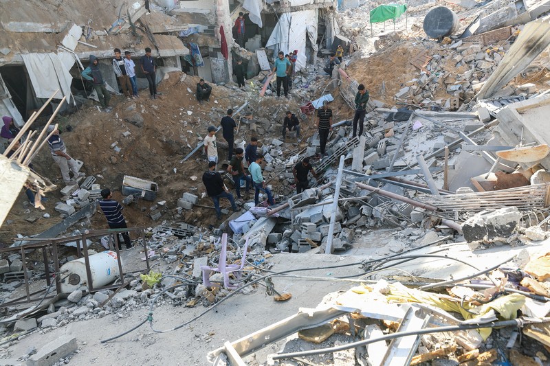 Palestinians inspect the site of an Israeli strike on a house, in Jabalia, in the northern Gaza Strip, May 16, 2025. REUTERS/Mahmoud Issa