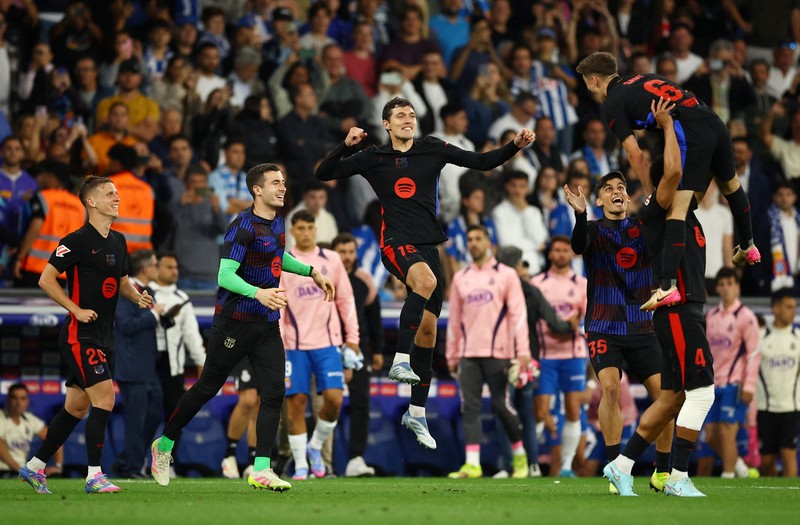 Para pemain FC Barcelona Inaki Pena, Dani Olmo, Andreas Christensen, Gerard Martin, dan Gavi merayakan kemenangan tim setelah memastikan gelar juara LaLiga usai mengalahkan Espanyol di Stadion RCDE, Cornella de Llobregat, Spanyol, Kamis (15/5/2025). (REUTERS/Albert Gea)