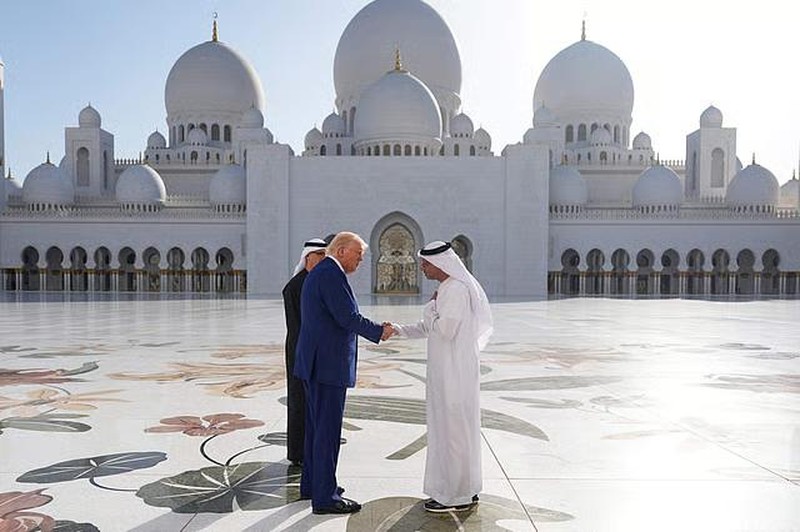 USA-TRUMP/GULF-EMIRATES U.S. President Donald Trump is reflected off the floor as he walks with Yousif Al Obaidli, director of Sheikh Zayed Grand Mosque and Ameena Al Hammadi, acting director of the Culture and Knowledge Department while visiting the Sheikh Zayed Grand Mosque in Abu Dhabi, United Arab Emirates, May 15, 2025. REUTERS/Brian Snyder