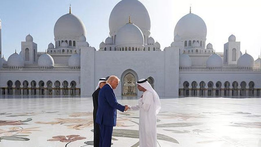 U.S. President Donald Trump is reflected off the floor as he walks with Yousif Al Obaidli, director of Sheikh Zayed Grand Mosque and Ameena Al Hammadi, acting director of the Culture and Knowledge Department while visiting the Sheikh Zayed Grand Mosque in Abu Dhabi, United Arab Emirates, May 15, 2025. REUTERS/Brian Snyder