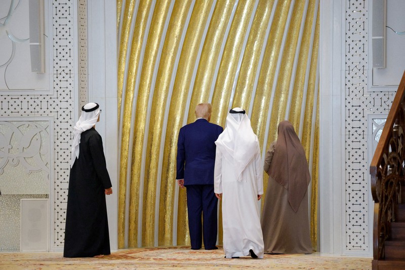 U.S. President Donald Trump is reflected off the floor as he walks with Yousif Al Obaidli, director of Sheikh Zayed Grand Mosque and Ameena Al Hammadi, acting director of the Culture and Knowledge Department while visiting the Sheikh Zayed Grand Mosque in Abu Dhabi, United Arab Emirates, May 15, 2025. REUTERS/Brian Snyder