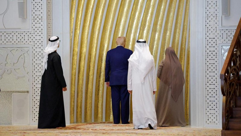 U.S. President Donald Trump is reflected off the floor as he walks with Yousif Al Obaidli, director of Sheikh Zayed Grand Mosque and Ameena Al Hammadi, acting director of the Culture and Knowledge Department while visiting the Sheikh Zayed Grand Mosque in Abu Dhabi, United Arab Emirates, May 15, 2025. REUTERS/Brian Snyder