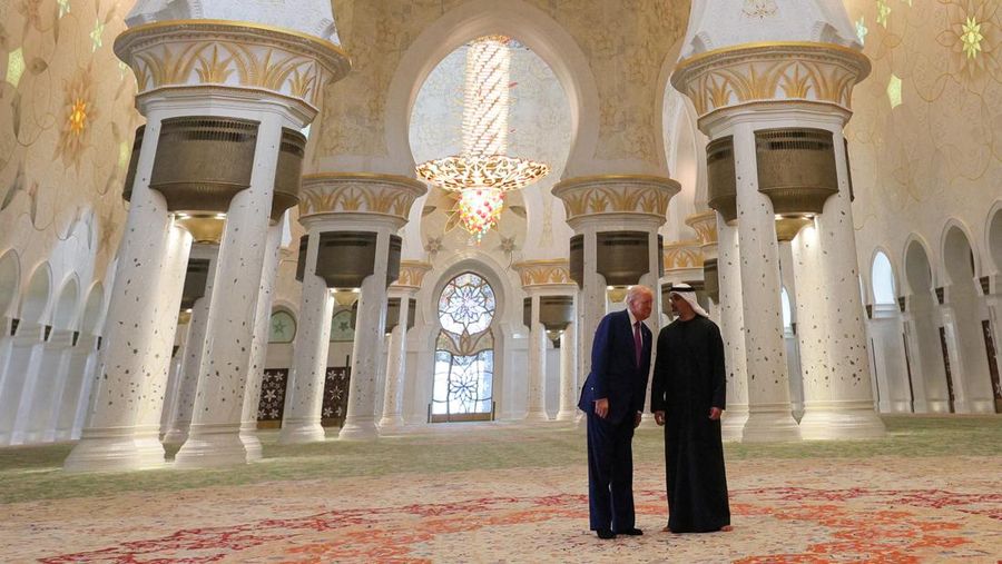 U.S. President Donald Trump is reflected off the floor as he walks with Yousif Al Obaidli, director of Sheikh Zayed Grand Mosque and Ameena Al Hammadi, acting director of the Culture and Knowledge Department while visiting the Sheikh Zayed Grand Mosque in Abu Dhabi, United Arab Emirates, May 15, 2025. REUTERS/Brian Snyder