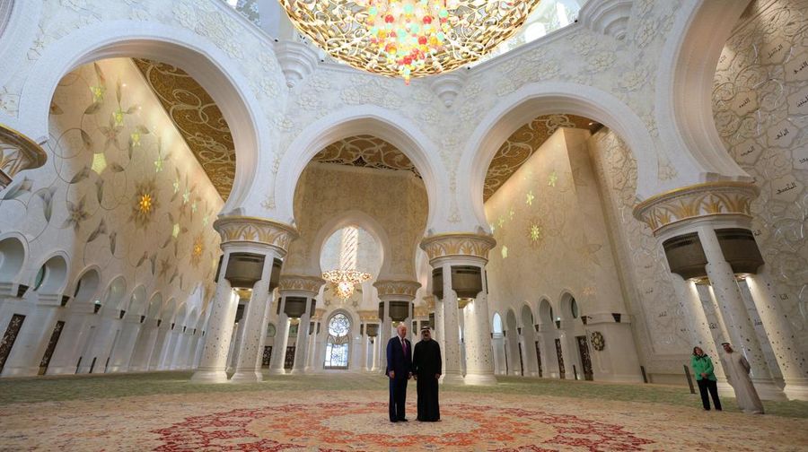 U.S. President Donald Trump is reflected off the floor as he walks with Yousif Al Obaidli, director of Sheikh Zayed Grand Mosque and Ameena Al Hammadi, acting director of the Culture and Knowledge Department while visiting the Sheikh Zayed Grand Mosque in Abu Dhabi, United Arab Emirates, May 15, 2025. REUTERS/Brian Snyder