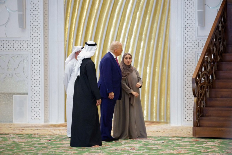 USA-TRUMP/GULF-EMIRATES U.S. President Donald Trump is reflected off the floor as he walks with Yousif Al Obaidli, director of Sheikh Zayed Grand Mosque and Ameena Al Hammadi, acting director of the Culture and Knowledge Department while visiting the Sheikh Zayed Grand Mosque in Abu Dhabi, United Arab Emirates, May 15, 2025. REUTERS/Brian Snyder