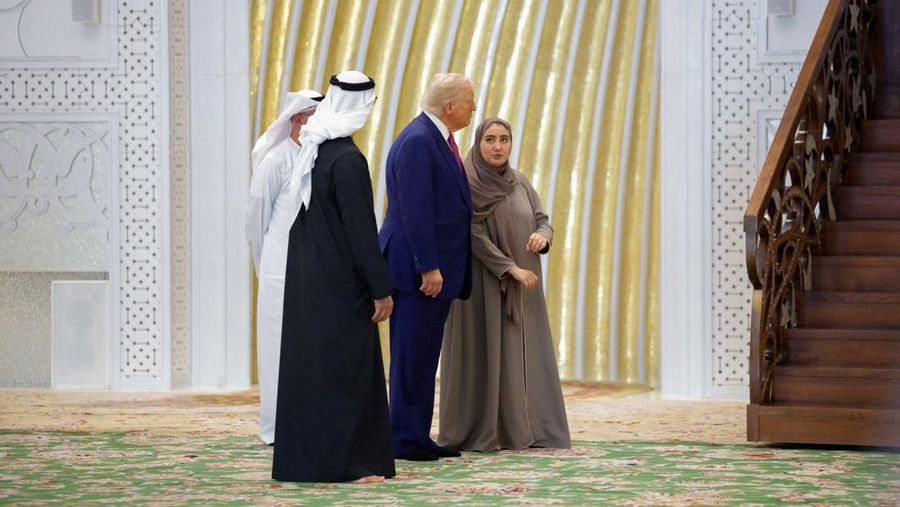 U.S. President Donald Trump is reflected off the floor as he walks with Yousif Al Obaidli, director of Sheikh Zayed Grand Mosque and Ameena Al Hammadi, acting director of the Culture and Knowledge Department while visiting the Sheikh Zayed Grand Mosque in Abu Dhabi, United Arab Emirates, May 15, 2025. REUTERS/Brian Snyder
